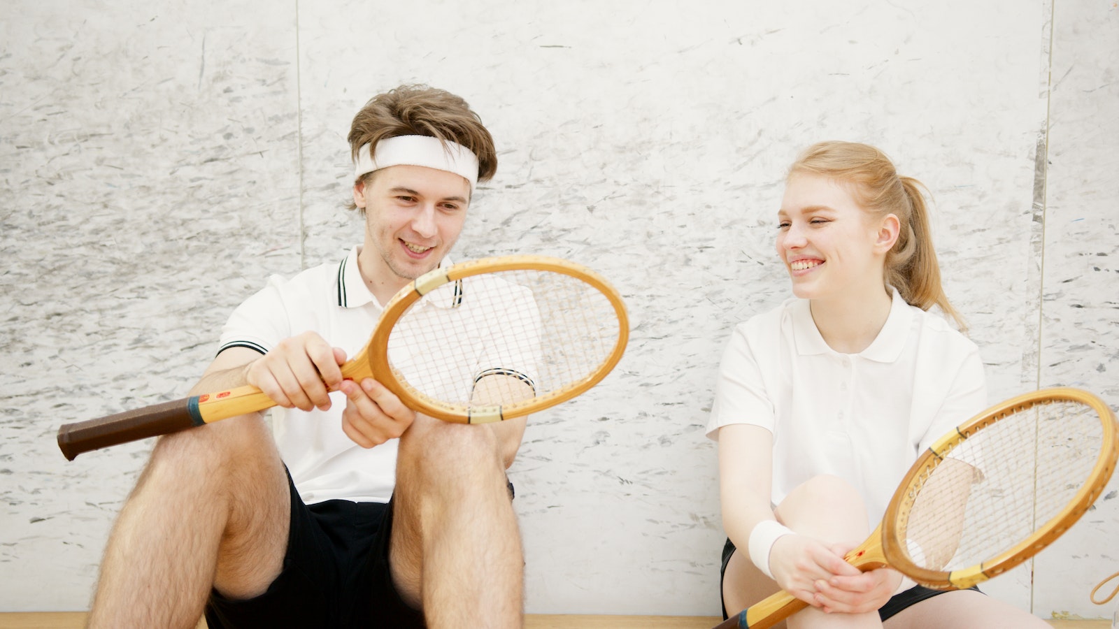 Young Squash Players Sitting Together