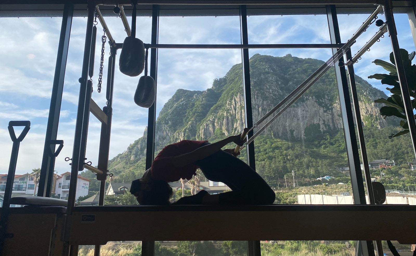 a person standing on a ledge in front of a window